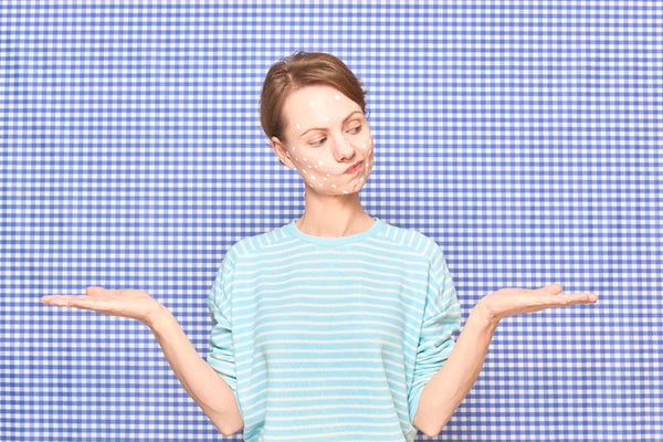 An image depicts a woman wearing a cozy blue sweater, with her hands outstretched in a gesture of uncertainty